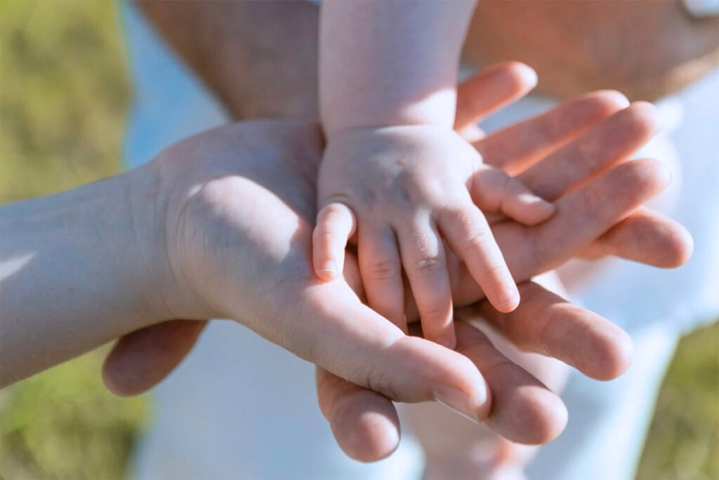 Hands of a family joining lovingly
