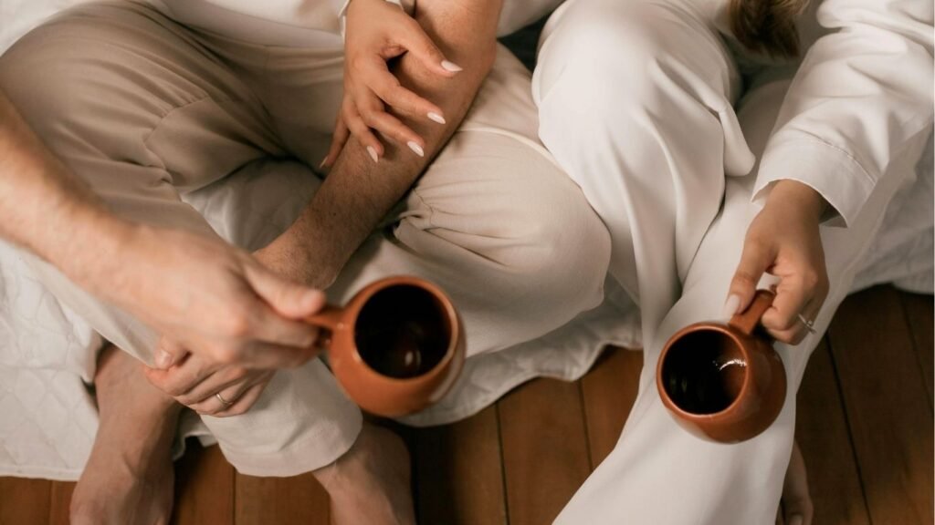 Couple sitting on the floor, having coffee and connecting