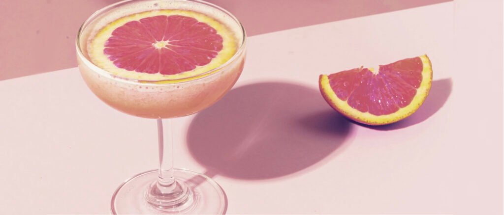 Image of a pink drink with pomelo slices